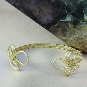 Gold cuff wrapped bracelet.